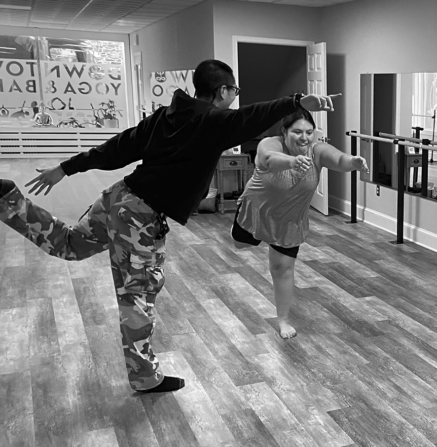 Andres and Hannah in a yoga pose.